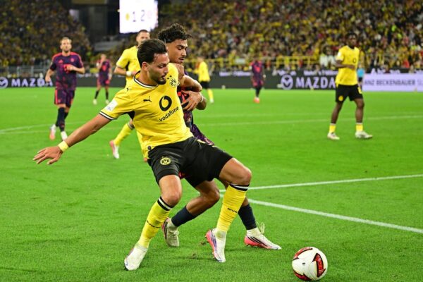 Dortmund's Bensebaini Battles Pain Before Red Card Ends Super Cup Night