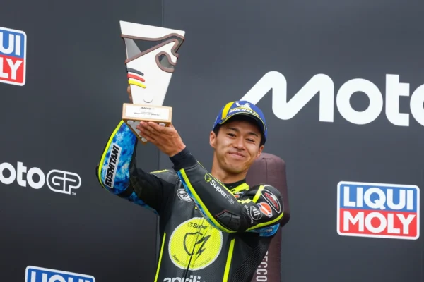 Ai Ogura Yamaha signing holds up a trophy on the podium at the 2026 Sachsenring MotoGP round