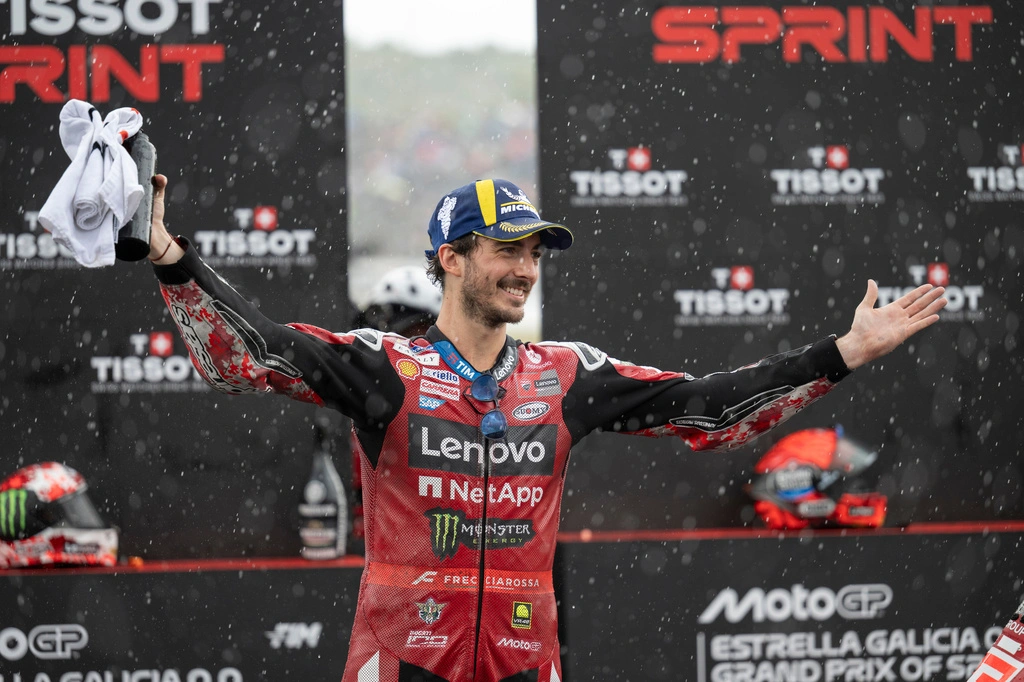 Francesco Bagnaia smiles with arms spread in Ducati Lenovo Team leathers after finishing second in the MotoGP Sprint at Jerez